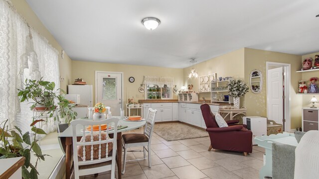 4936 Grassy Pond Rd, Chipley, FL 32428 - kitchen with white cabinets, light tile patterned floors, and freestanding refrigerator