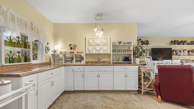 4936 Grassy Pond Rd, Chipley, FL 32428 - kitchen featuring white cabinetry, light tile patterned floors, and decorative light fixtures
