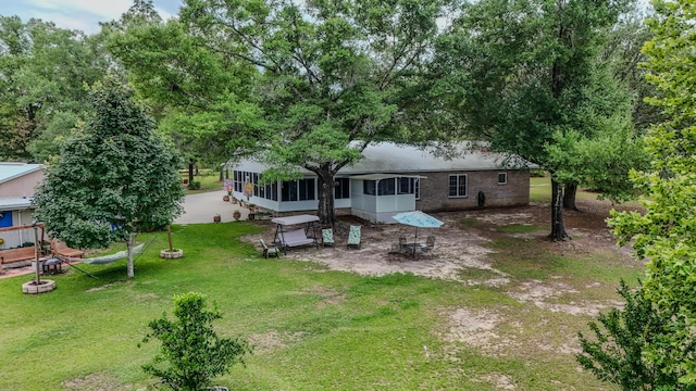 4936 Grassy Pond Rd, Chipley, FL 32428 - rear view of property featuring a sunroom and a lawn