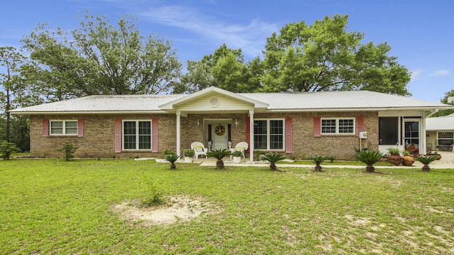 4936 Grassy Pond Rd, Chipley, FL 32428 - single story home featuring a front lawn, brick siding, and a sunroom