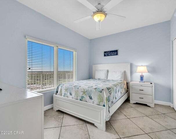 9900 S Thomas Dr Unit 1604, Panama City Beach, FL 32408 - bedroom with light tile patterned flooring and a ceiling fan