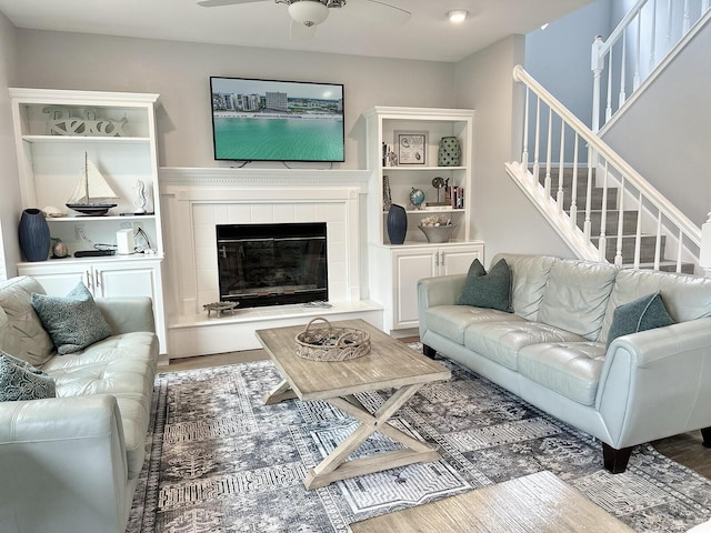 83 Sunfish St, Destin, FL 32541 - living room with a ceiling fan, a tile fireplace, stairs, and wood finished floors