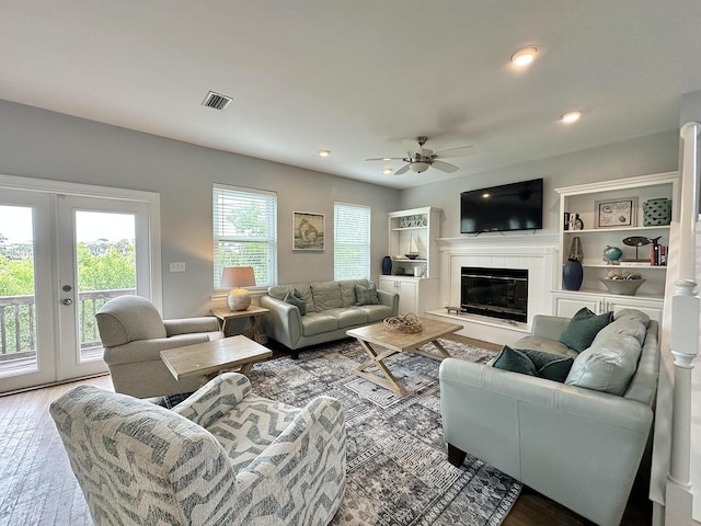 83 Sunfish St, Destin, FL 32541 - living area with wood finished floors, a ceiling fan, french doors, a tile fireplace, and recessed lighting
