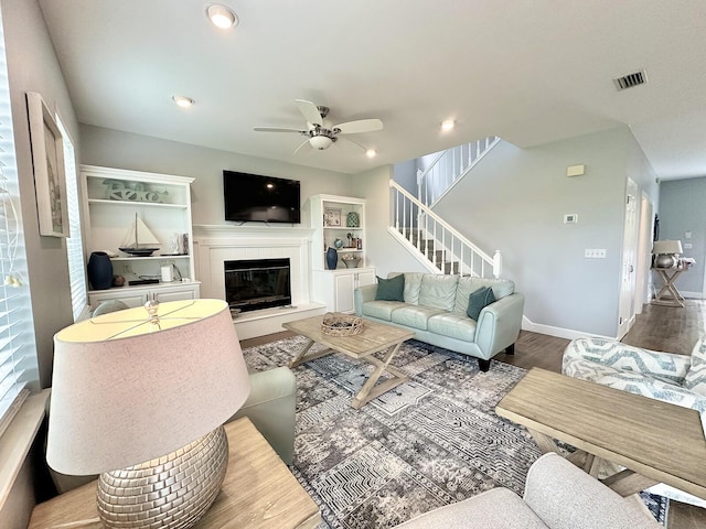 83 Sunfish St, Destin, FL 32541 - living room featuring a fireplace, a ceiling fan, wood finished floors, stairs, and recessed lighting