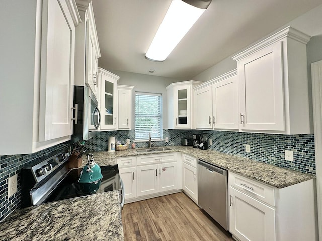 83 Sunfish St, Destin, FL 32541 - kitchen with appliances with stainless steel finishes, white cabinets, decorative backsplash, and light stone countertops
