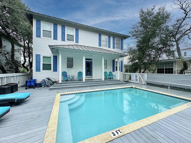 83 Sunfish St, Destin, FL 32541 - back of house featuring an outdoor pool, a deck, a standing seam roof, and a metal roof