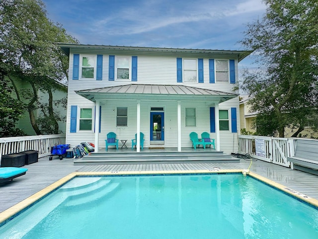 83 Sunfish St, Destin, FL 32541 - rear view of property with an outdoor pool, a standing seam roof, a metal roof, and a wooden deck