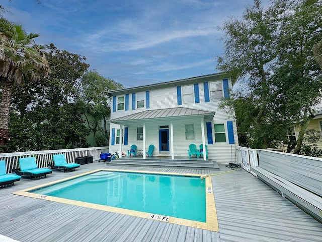 83 Sunfish St, Destin, FL 32541 - back of property featuring a metal roof, a wooden deck, a standing seam roof, and an outdoor hangout area