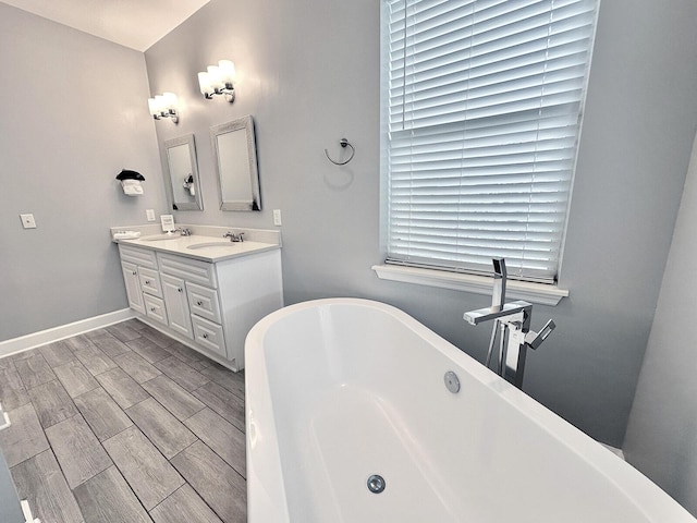 83 Sunfish St, Destin, FL 32541 - full bath featuring a freestanding bath, double vanity, and wood finish floors