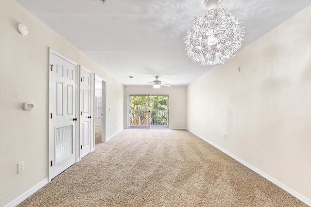 4276 Calinda Ln Apt 138, Niceville, FL 32578 - carpeted empty room featuring ceiling fan, a smoke detector, and a chandelier