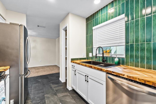 4276 Calinda Ln Apt 138, Niceville, FL 32578 - kitchen featuring stainless steel appliances, butcher block countertops, and white cabinetry