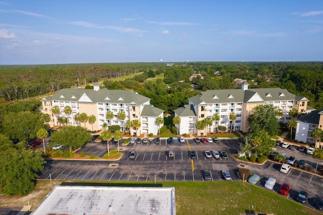 4276 Calinda Ln Apt 138, Niceville, FL 32578 - aerial view of property and surrounding area featuring a heavily wooded area