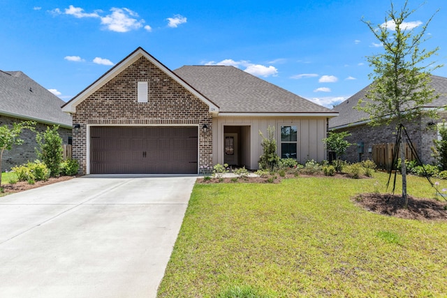124 Apollo Ave, Freeport, FL 32439 - view of front facade featuring brick siding, an attached garage, a front lawn, driveway, and board and batten siding