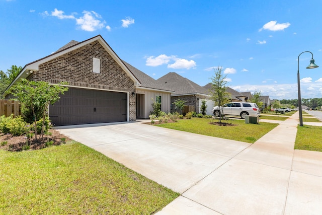 124 Apollo Ave, Freeport, FL 32439 - view of front of home with brick siding, concrete driveway, a front lawn, an attached garage, and roof with shingles