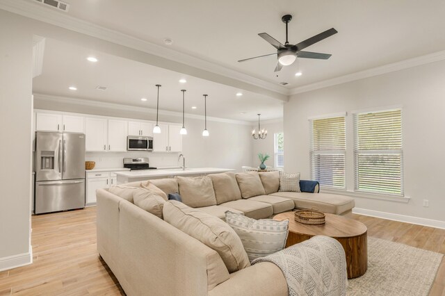 124 Apollo Ave, Freeport, FL 32439 - living area featuring a chandelier, recessed lighting, a ceiling fan, light wood-style floors, and crown molding