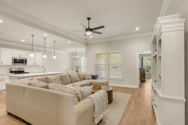 124 Apollo Ave, Freeport, FL 32439 - living room featuring ceiling fan, recessed lighting, light wood-type flooring, a chandelier, and ornamental molding