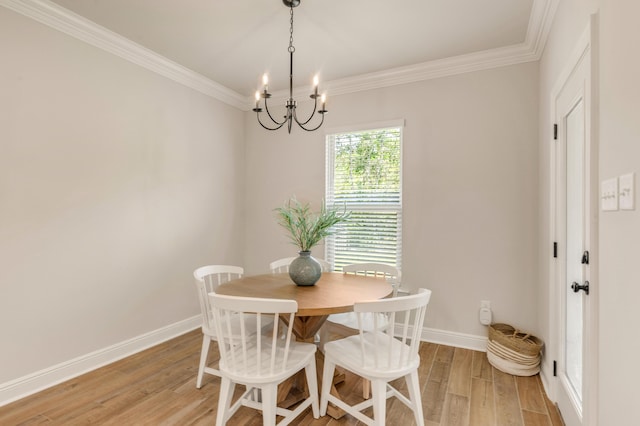 124 Apollo Ave, Freeport, FL 32439 - dining space with a chandelier, light wood-type flooring, and ornamental molding