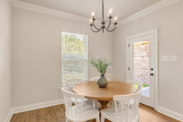 124 Apollo Ave, Freeport, FL 32439 - dining area featuring a chandelier, crown molding, and light wood finished floors