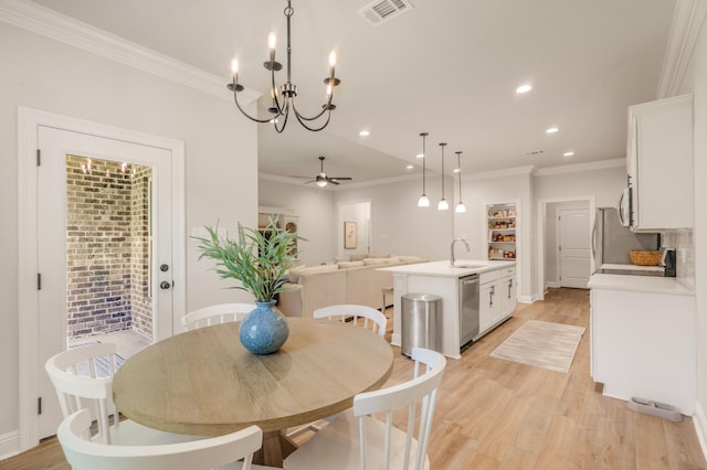 124 Apollo Ave, Freeport, FL 32439 - dining room with ornamental molding, light wood-style floors, recessed lighting, a ceiling fan, and a chandelier