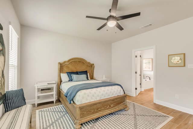 124 Apollo Ave, Freeport, FL 32439 - bedroom featuring light wood finished floors, ensuite bathroom, and ceiling fan