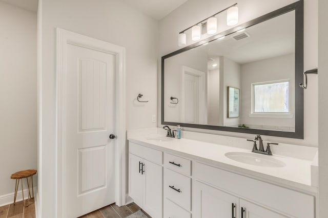 124 Apollo Ave, Freeport, FL 32439 - full bathroom featuring double vanity and wood finished floors