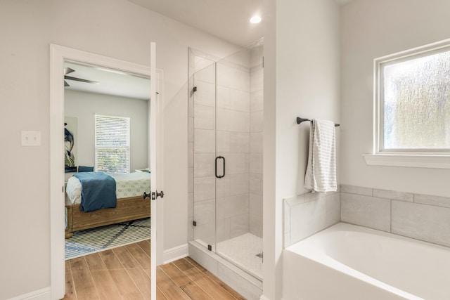 124 Apollo Ave, Freeport, FL 32439 - ensuite bathroom featuring a stall shower, a garden tub, wood finished floors, and recessed lighting