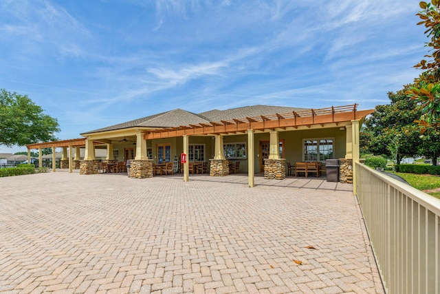 124 Apollo Ave, Freeport, FL 32439 - rear view of house with stucco siding, ceiling fan, a pergola, and stone siding