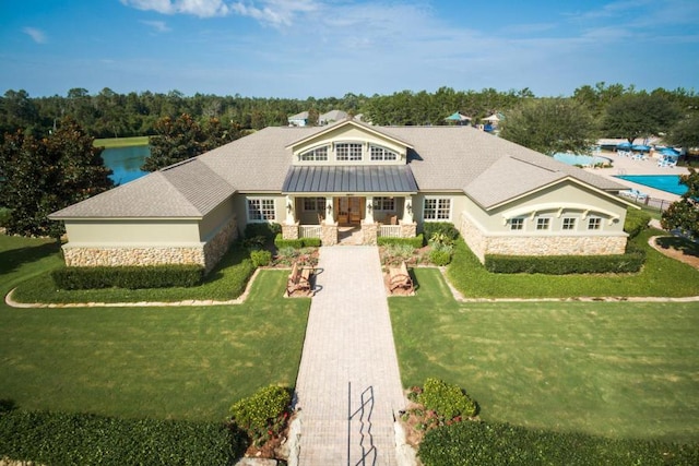 124 Apollo Ave, Freeport, FL 32439 - view of front of house with stone siding, a front yard, and a porch
