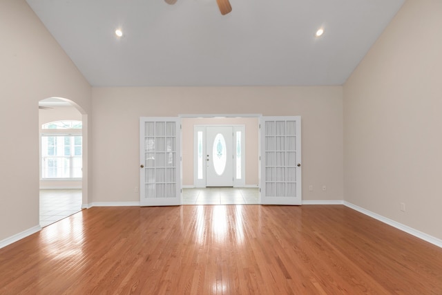 5552 Frontier Dr, Crestview, FL 32536 - entrance foyer with a ceiling fan, light wood-type flooring, arched walkways, and vaulted ceiling
