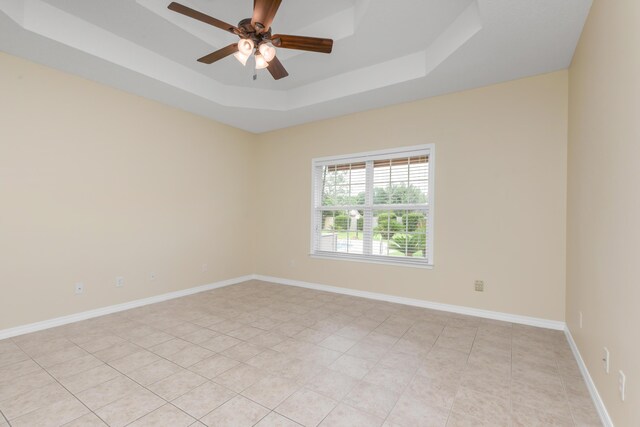 5552 Frontier Dr, Crestview, FL 32536 - spare room with a raised ceiling, a ceiling fan, and light tile patterned floors