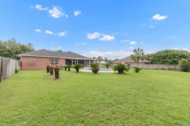5552 Frontier Dr, Crestview, FL 32536 - fenced backyard featuring a sunroom