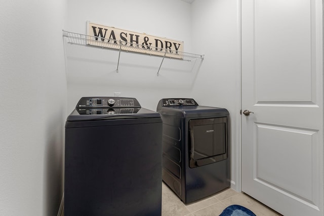 8668 Shell Sink Dr, Panama City Beach, FL 32413 - laundry room featuring washer and dryer and light tile patterned flooring