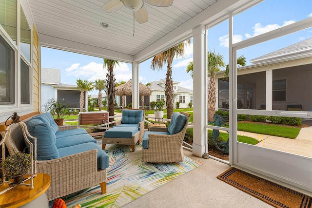 8668 Shell Sink Dr, Panama City Beach, FL 32413 - sunroom / solarium featuring an outdoor hangout area, ceiling fan, carpet, and floor to ceiling windows