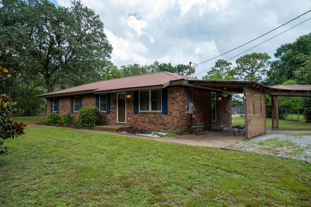 3180 Palmetta Ave, Crestview, FL 32539 - ranch-style house with a carport, a front yard, brick siding, and a metal roof