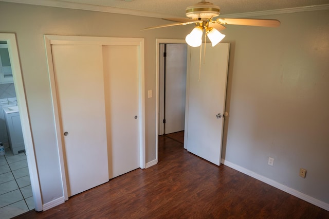 3180 Palmetta Ave, Crestview, FL 32539 - unfurnished bedroom featuring ornamental molding, dark wood-type flooring, washer / dryer, and ceiling fan
