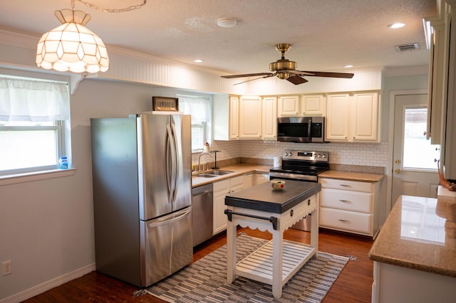 3180 Palmetta Ave, Crestview, FL 32539 - kitchen with appliances with stainless steel finishes, plenty of natural light, a ceiling fan, tasteful backsplash, and a textured ceiling
