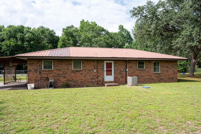 3180 Palmetta Ave, Crestview, FL 32539 - rear view of house featuring brick siding, a carport, and a metal roof