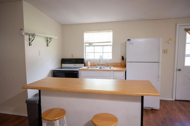 3180 Palmetta Ave, Crestview, FL 32539 - kitchen with white appliances, white cabinets, dark wood finished floors, a breakfast bar area, and wood counters