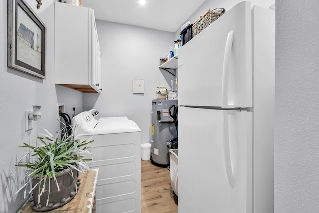 52 Lazy Bone St, Vernon, FL 32462 - laundry room featuring water heater, cabinet space, light wood-style flooring, and separate washer and dryer