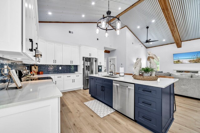 52 Lazy Bone St, Vernon, FL 32462 - kitchen featuring stainless steel appliances, open floor plan, blue cabinetry, a ceiling fan, and white cabinets