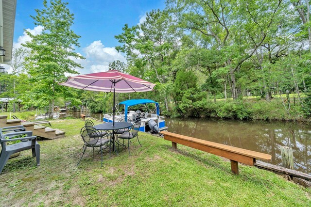52 Lazy Bone St, Vernon, FL 32462 - dock area with a lawn, a water view, view of scattered trees, and outdoor dining space