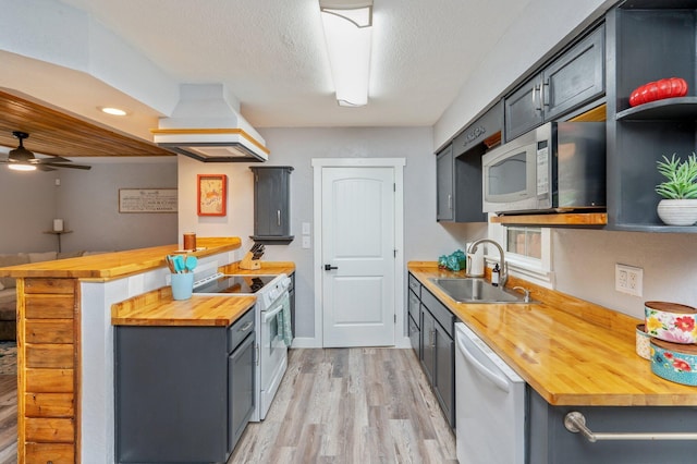 201 Anderson St, Crestview, FL 32536 - kitchen featuring wooden counters, white appliances, premium range hood, light wood finished floors, and a peninsula