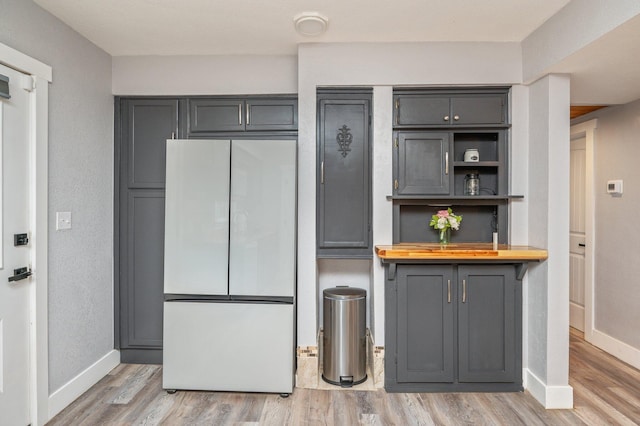 201 Anderson St, Crestview, FL 32536 - kitchen with freestanding refrigerator, gray cabinetry, light wood-type flooring, and butcher block counters