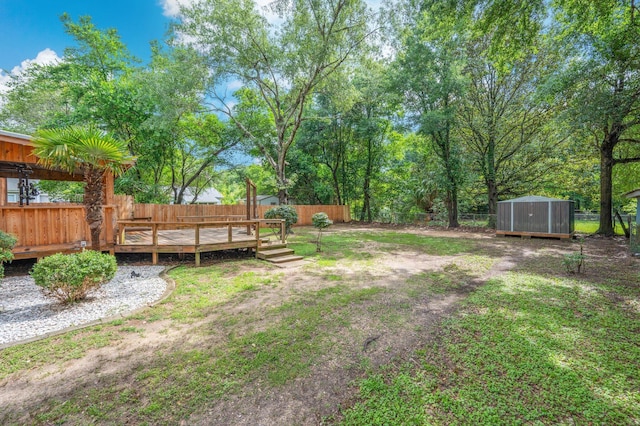 201 Anderson St, Crestview, FL 32536 - fenced backyard with a storage unit and a wooden deck