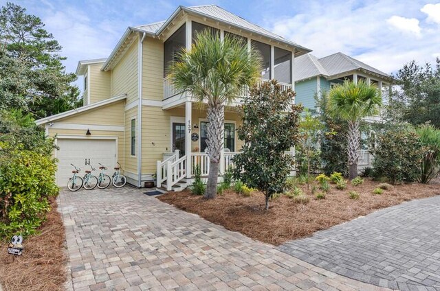 137 Cabana Trl, Santa Rosa Beach, FL 32459 - view of front of house featuring a garage, decorative driveway, and covered porch