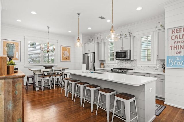 137 Cabana Trl, Santa Rosa Beach, FL 32459 - kitchen with stainless steel appliances, plenty of natural light, a breakfast bar, decorative backsplash, and crown molding
