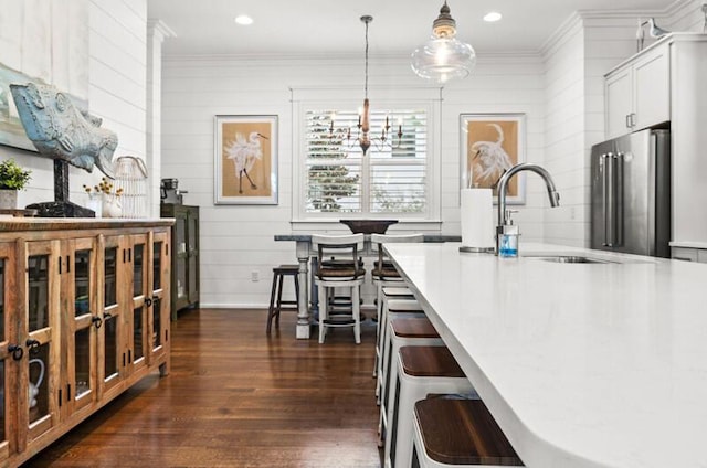 137 Cabana Trl, Santa Rosa Beach, FL 32459 - kitchen with high end fridge, ornamental molding, dark wood finished floors, light countertops, and hanging light fixtures
