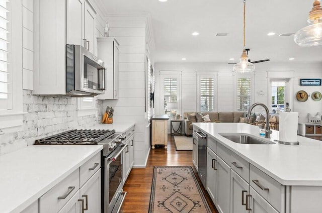 137 Cabana Trl, Santa Rosa Beach, FL 32459 - kitchen with stainless steel appliances, light countertops, open floor plan, decorative backsplash, and dark wood finished floors