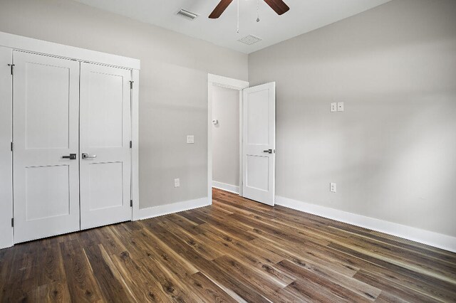 3112 Evans Ave, Navarre, FL 32566 - unfurnished bedroom with dark wood-type flooring, ceiling fan, and a closet