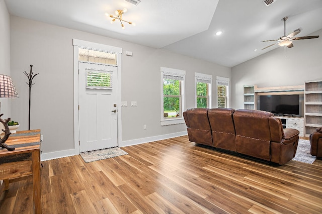 3112 Evans Ave, Navarre, FL 32566 - living room featuring healthy amount of natural light, vaulted ceiling, light wood-style floors, ceiling fan, and recessed lighting